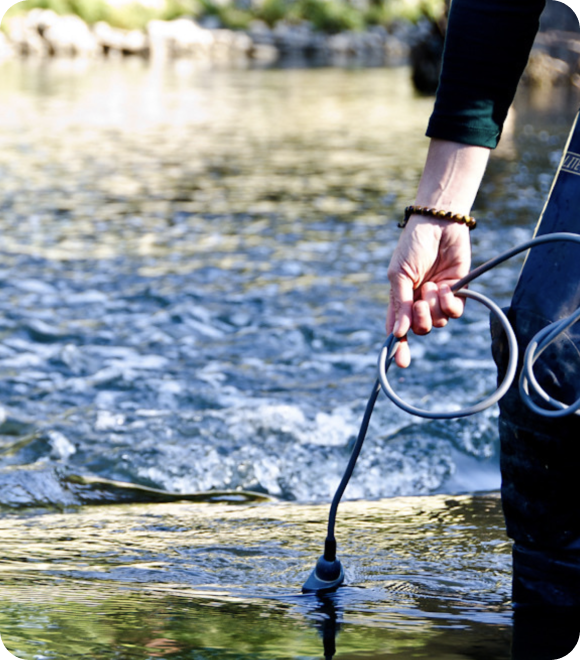 Person offscreen checking water with device