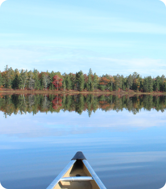 Front tip of canoe on lake